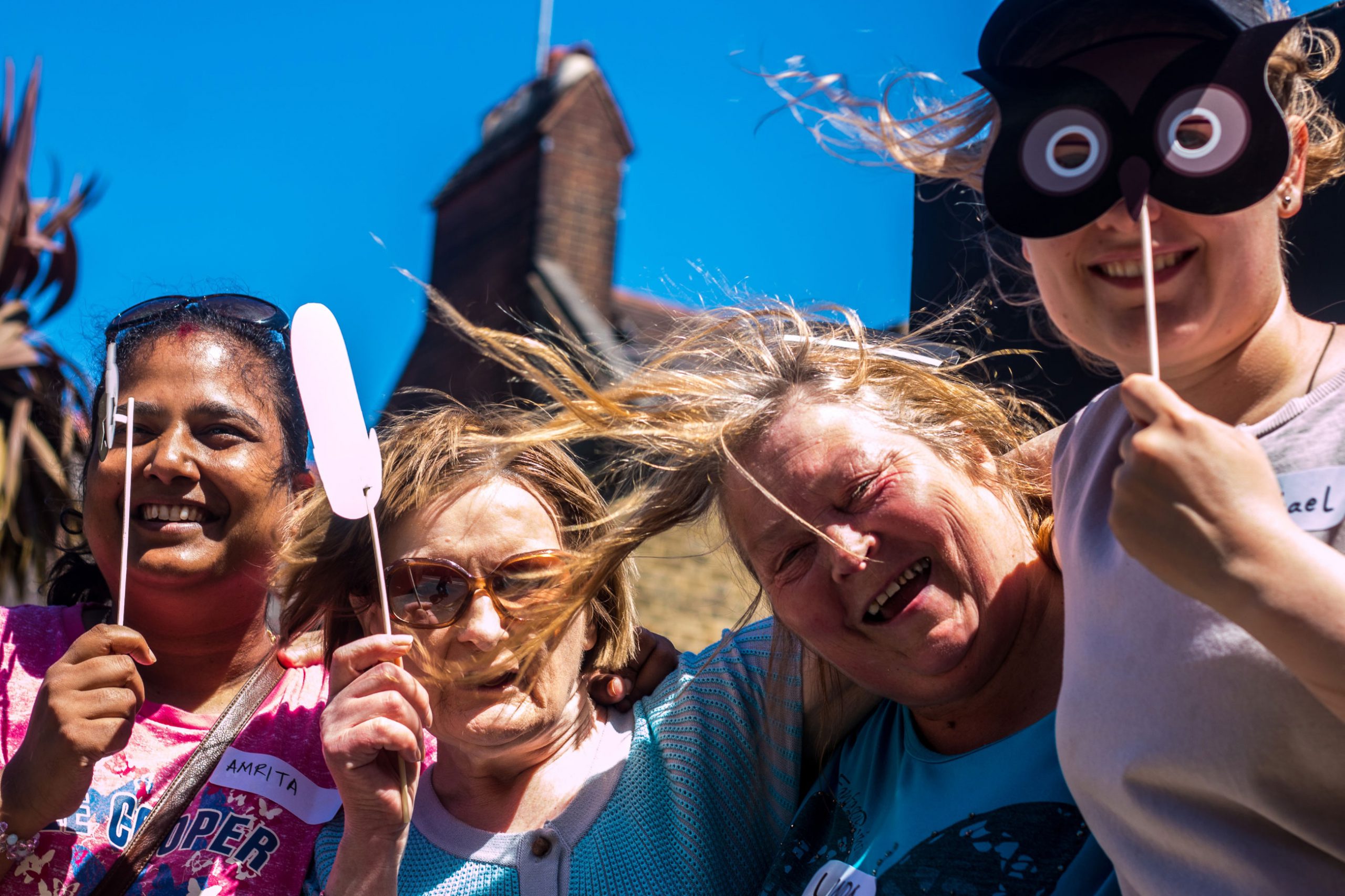 Four smiling ladies at a street party